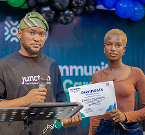 Junction community member holding an award